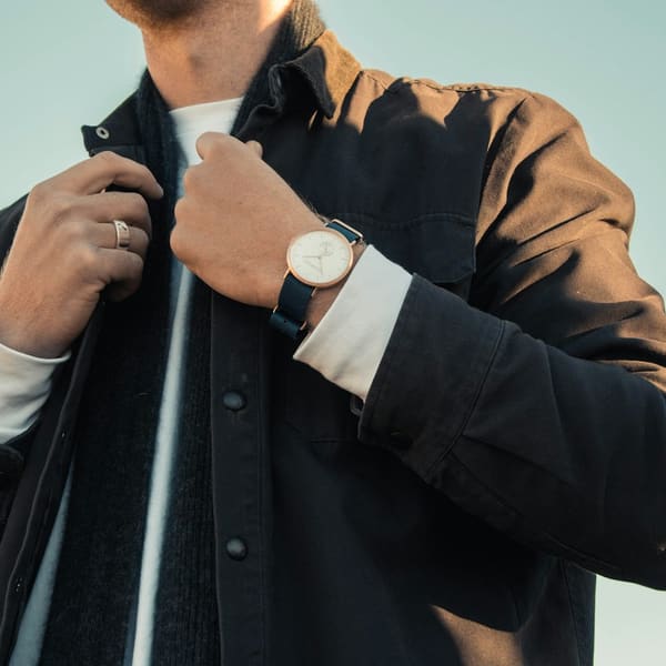 Model buttoning a shirt